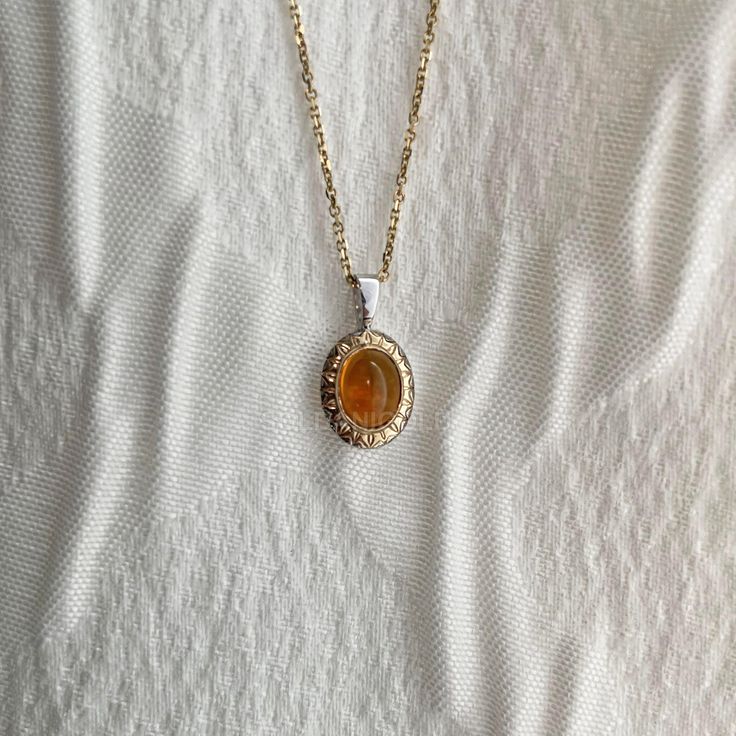 Add some sunshine to your jewelry collection with this vibrant Citrine Cabochon Two-Tone Pendant Necklace. The bezel-set citrine cabochon is accented by a beautiful golden sun motif. The warm, golden hues of the citrine pair perfectly with the two-tone gold setting. Also available as single-tone gold, you can further personalize this pendant with your favorite Cabochon stone! Simply reach out to me and we can figure out what stone works best for you. A great gift for anyone who appreciates uniqu Gold Oval Jewelry With Gemstone Accents, Oval Cabochon Necklaces In Fine Jewelry Style, Oval Gold Jewelry With Gemstone Accents, Oval Cabochon Necklace In Fine Jewelry Style, Fine Jewelry Oval Gold Gemstones, Oval Amber Necklace For Anniversary, Yellow Gold Oval Cabochon Jewelry, Oval Gold Gemstones For Anniversary, Oval Cabochon Yellow Gold Jewelry