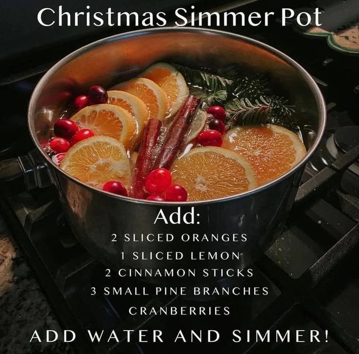 a pot filled with orange slices and cranberries