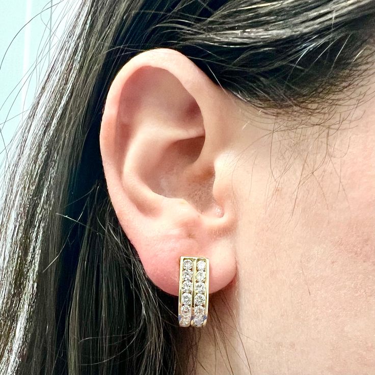 Fine pair of vintage 14 karat yellow gold diamond huggie earrings. They are channel set with 2 rows of round diamonds weighing approximately 2.75 carats (32 stones). The diamonds are F-G in color and VS-SI in clarity. Stamped 14k. Weighs 7.49 grams. L: 0.72 inch (1.85 cm). W: 7.57 mm. Closure: Omega Backs/Clip-On. Birthstone: April. Condition: Excellent. Faint wear throughout metal. - 14 day return policy, no questions asked. - Free insured shipping in the US. - International shipping available. Classic Yellow Gold Diamond Cut Huggie Earrings, Modern Round Diamond-cut Huggie Earrings, Gold Diamond-cut Huggie Jewelry, Fine Jewelry Cubic Zirconia Huggie Earrings, Brilliant Cut, Luxury 14k Gold Diamond-cut Huggie Earrings, Diamond Huggie Earrings, Huggies Earrings, Round Diamonds, Gold Diamond