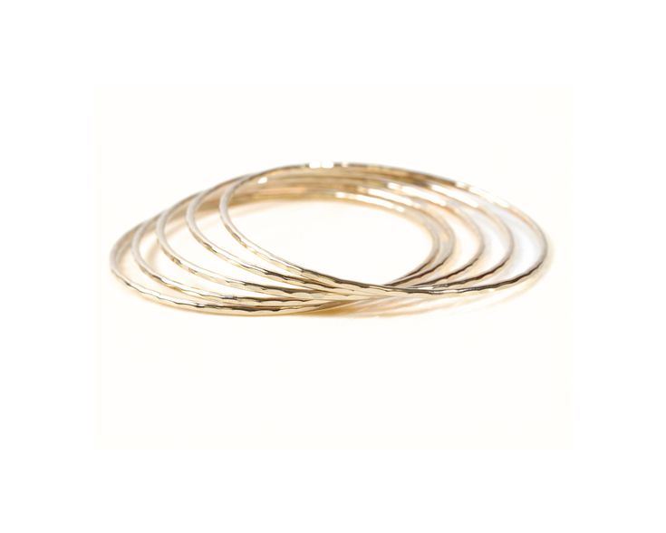 Elevate your style effortlessly with our Handmade 14K Gold Filled Stacking Bangles. These are sold individually. Increase the quantity at add to cart to build your stack. Handcrafted from exquisite 14K gold filled material, these bangles feature a unique hand-hammered texture, adding a touch of glamour and sophistication to any ensemble. Individually handmade by our team of talented artisans, these bangles provide a sensory delight with their smooth touch, delicate chime, and graceful movement a Elegant Stackable Brass Bangle, Everyday Gold Hammered Bangle, Stackable Yellow Gold Brass Bracelets, Stackable Dainty 14k Gold Bangle, Dainty Stackable 14k Gold Bangle, Dainty 14k Gold Stackable Bangle, Adjustable Stackable 14k Gold Bangle, Gold Stackable Brass Bangle, Elegant Gold Nickel-free Bangle