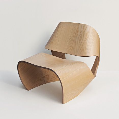 a wooden chair sitting on top of a white floor