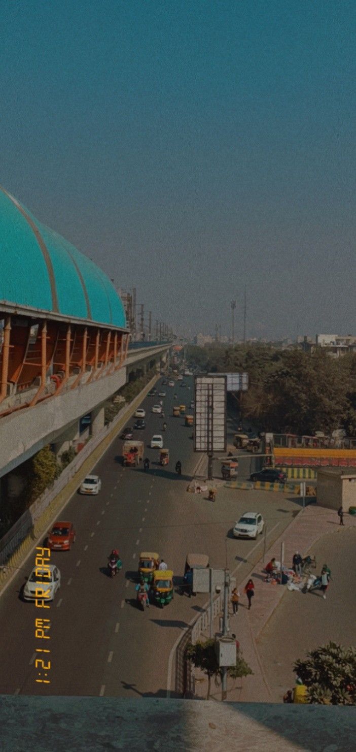 an airport with cars and trucks on the road