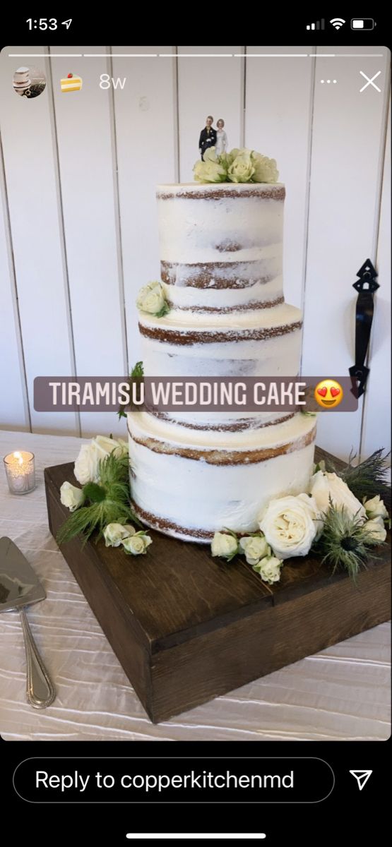 a wedding cake sitting on top of a wooden table