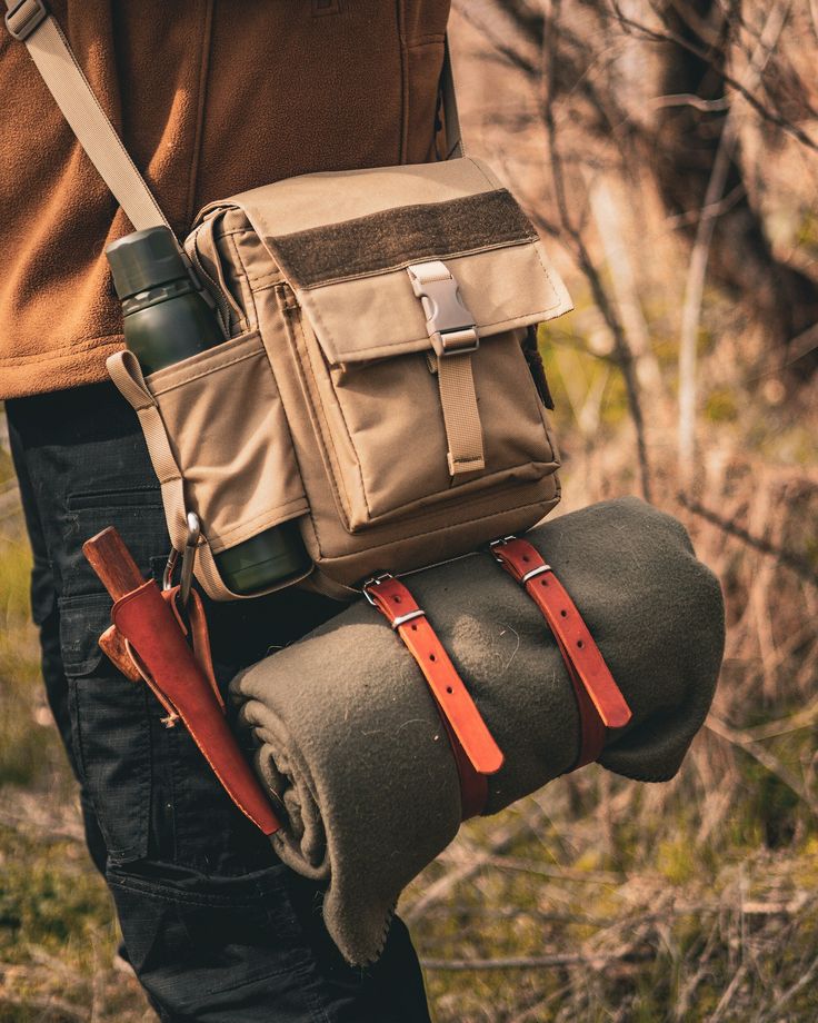 a person holding a bag and some items in their hands