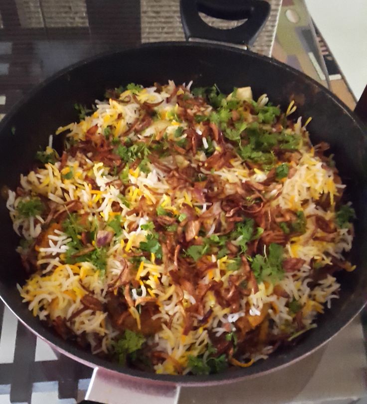 a pan filled with food sitting on top of a stove