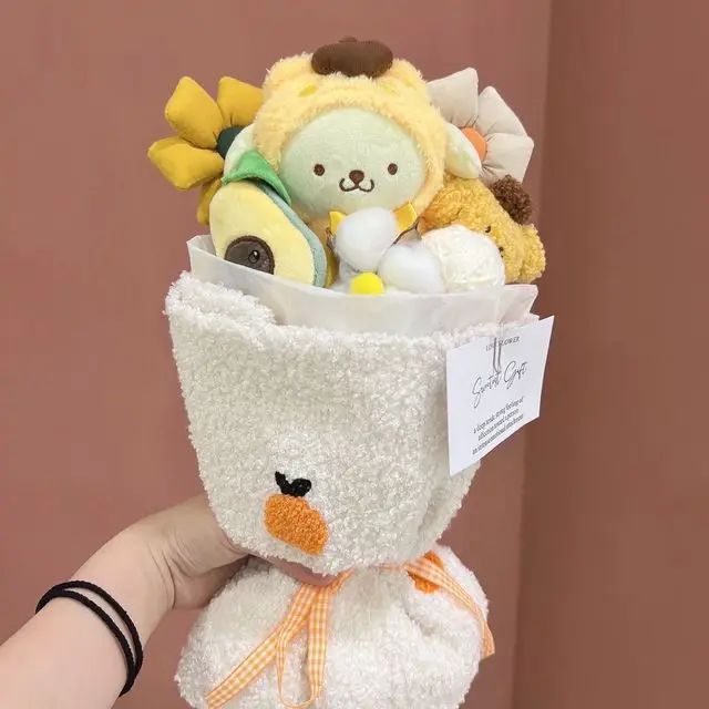 a person holding a stuffed animal in a small white cup filled with stuff animals and other items