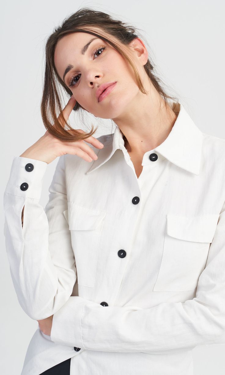 A linen shirt with fitted design, perfect for any woman who wants to stand out from the crowd with her extraordinary style. Features: Two patch front pockets with a flap Long sleeves Long asymmetric tail Made of linen Linen Button-up Work Shirt, Linen Button-up Shirt For Work, Chic Linen Blouse With Pockets, Shirt With Buttoned Pockets And Lapel Collar, Chic Shirt With Pockets And Lapel Collar, Modern Linen Blouse For Work, Buttoned Pockets Blouse With Shirttail Hem, Linen Tops With Button Cuffs For Work, Linen Tops With Spread Collar For Work