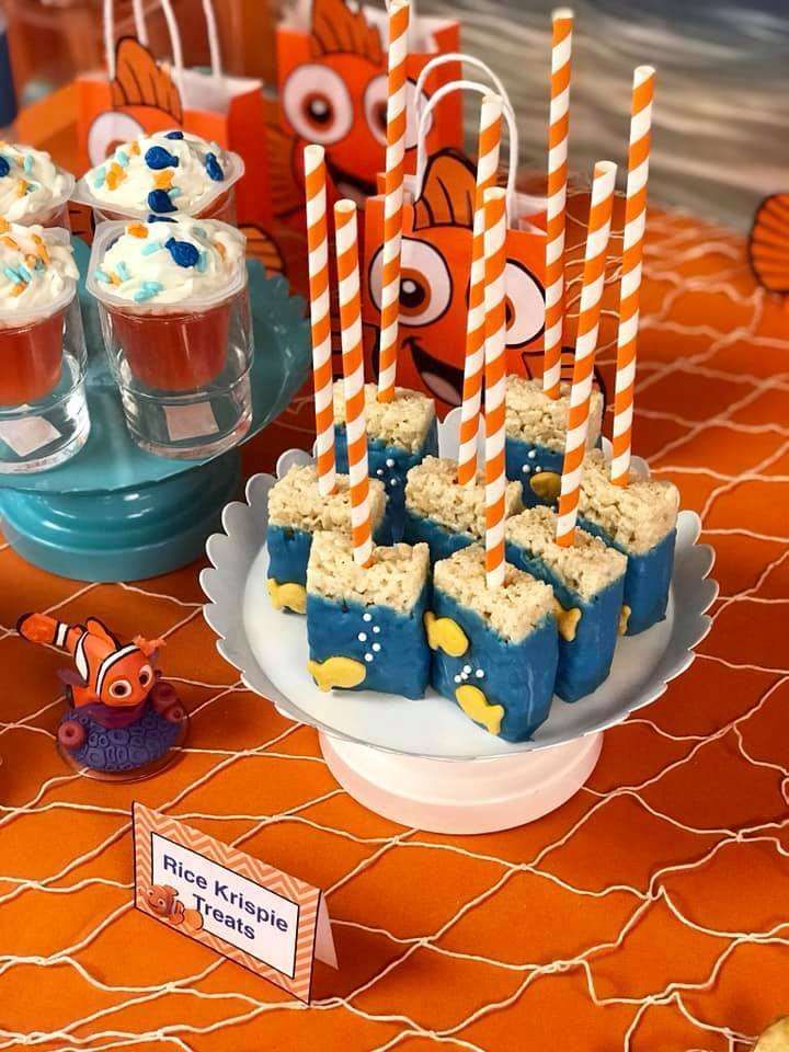 a table topped with desserts and cupcakes covered in frosting