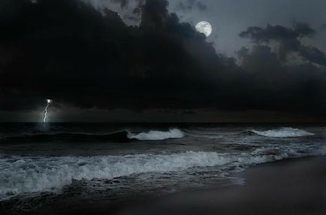 an image of a storm coming in from the ocean with lightning striking over the water