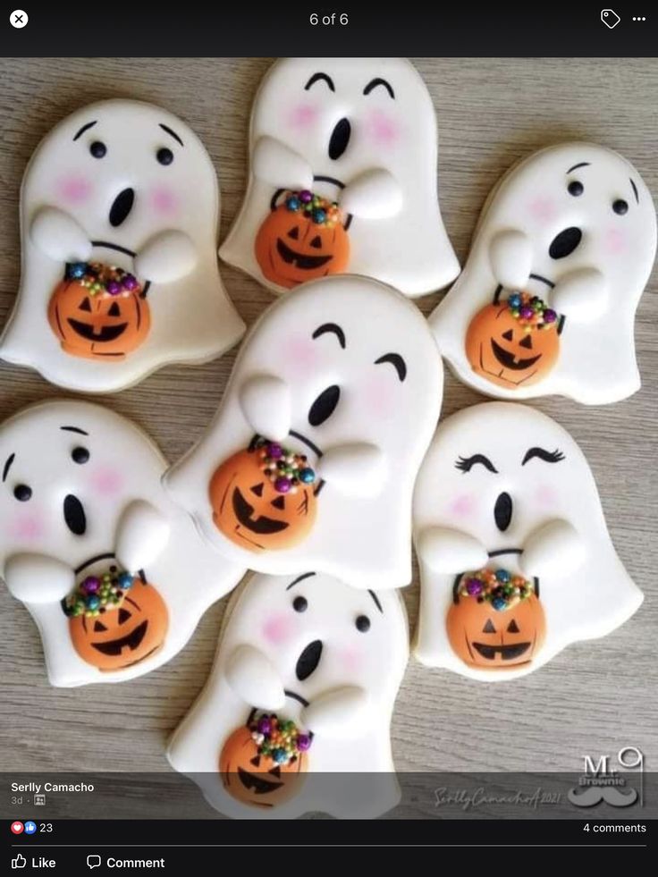 halloween ghost cookies decorated with sprinkles and candies are arranged on a table