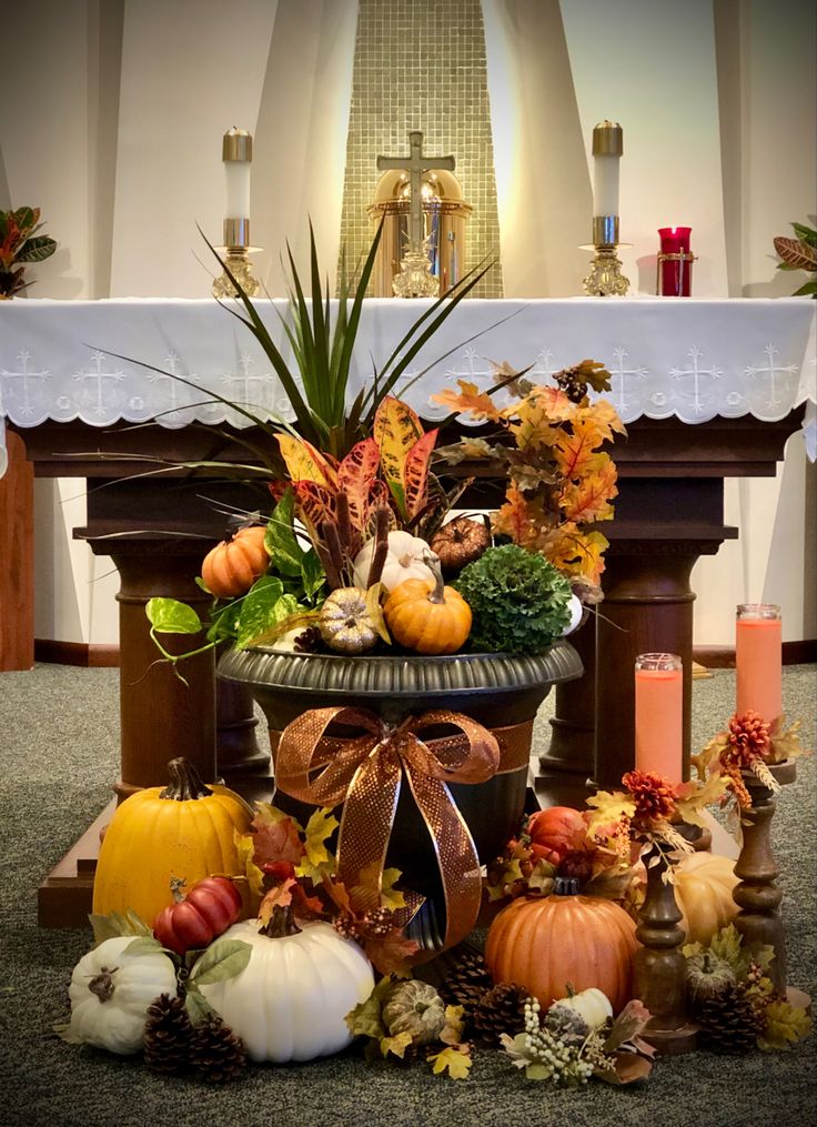 an arrangement of pumpkins, gourds and other autumn decorations