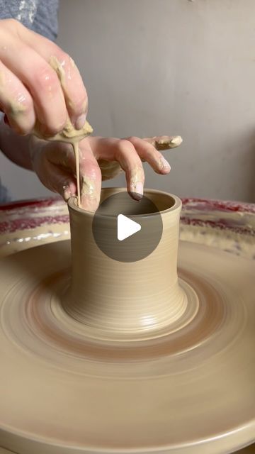 a person making a vase on a pottery wheel