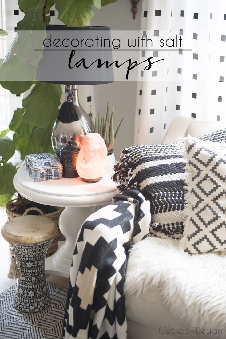 a living room with white furniture and black and white accessories on the table, along with text overlay that says decor with salt lamps