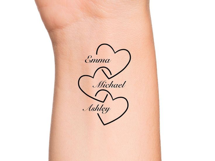 two hearts tattoo on the wrist with names in black ink, and three smaller hearts