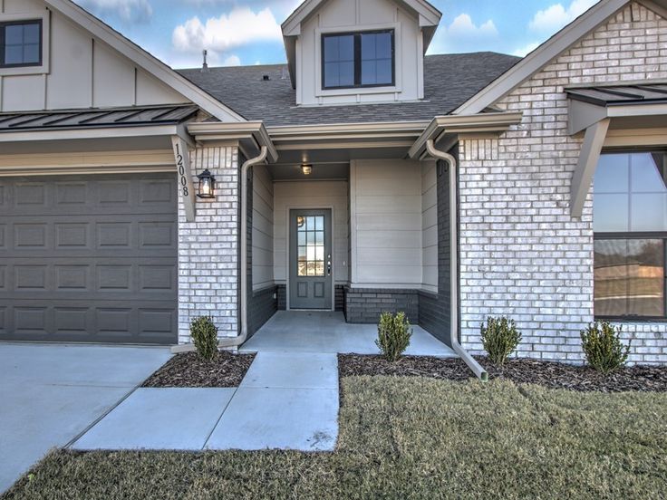 a house with two garages in front of it