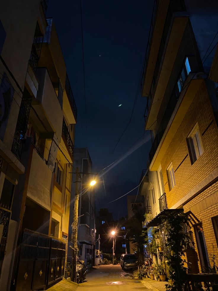 an empty street at night with no one on it or people walking down the road