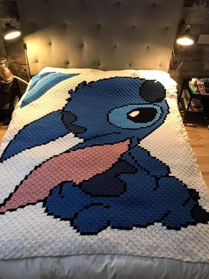 a crocheted stitched pokemon blanket on a bed