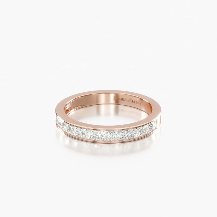 a rose gold wedding band with three princess cut diamonds on the side, set in 18k white gold