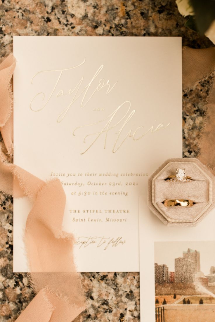 a wedding suite and ring on top of a table