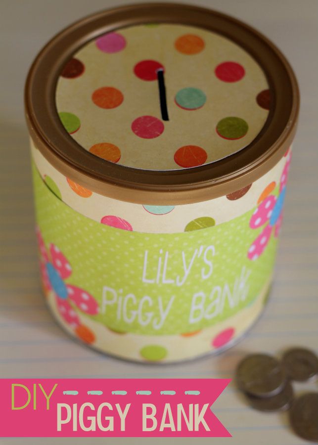 there is a small polka dot tin with a clock on it next to some coins