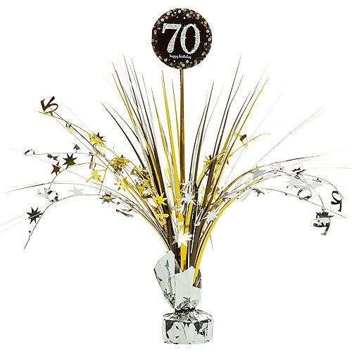 a vase filled with lots of gold and white flowers next to a sign that says 70