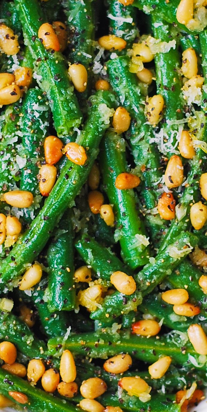 a white plate topped with green beans and broccoli