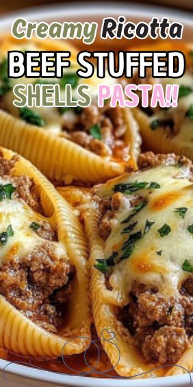 a white plate topped with stuffed shells covered in cheese