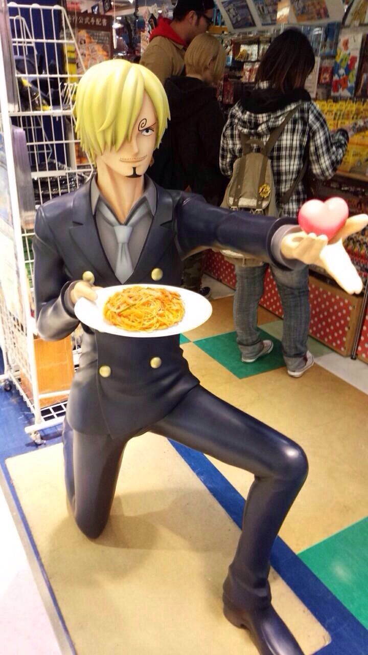 a statue of a man holding a plate of food in front of him with one hand