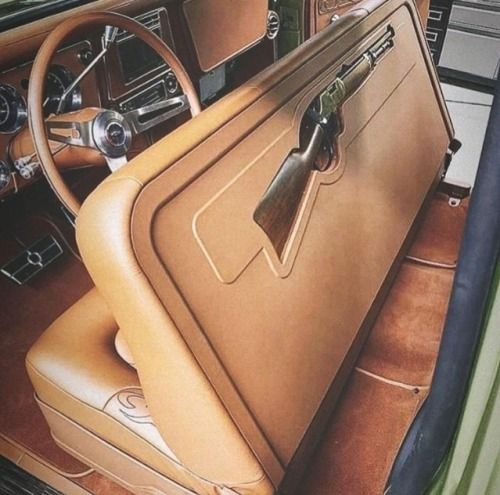 the interior of an old car with leather seats and steering wheel, including a seat cover