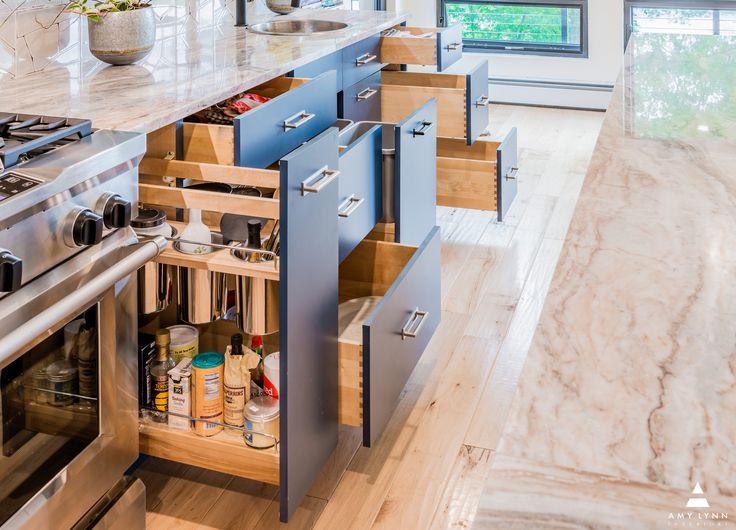 an open drawer in the middle of a kitchen