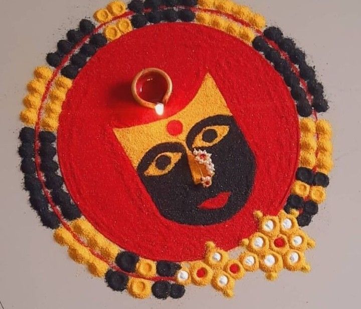 a red and yellow rug with a face on it next to a ring in the middle