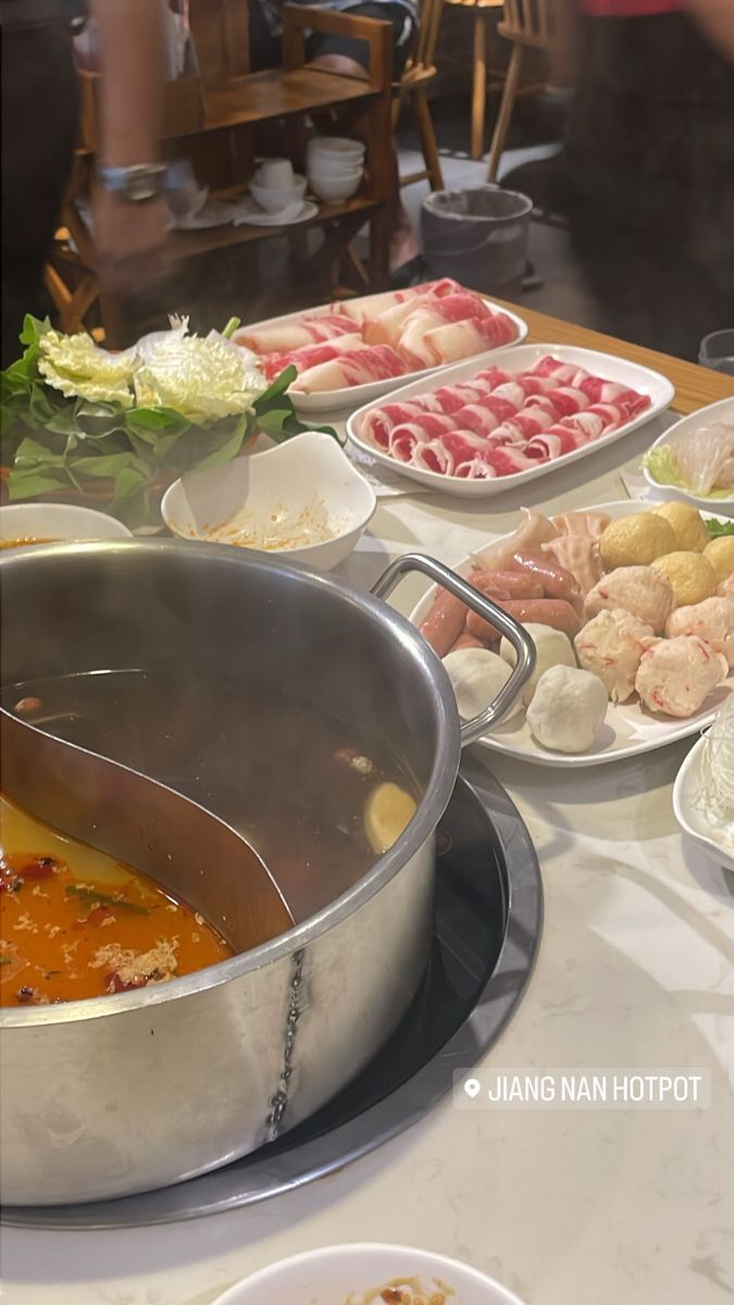 food is being prepared on a table with bowls and utensils in the foreground