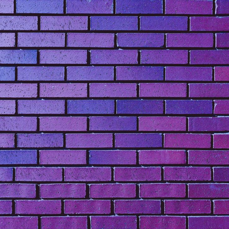 a purple brick wall that is very close to the ground