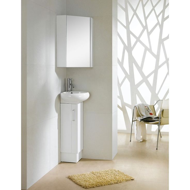 a white sink sitting next to a mirror in a bathroom