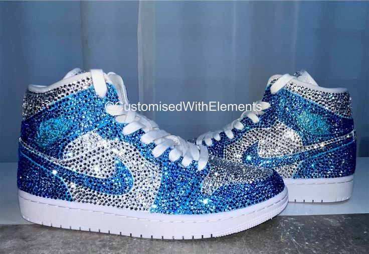 Stunning Nike Jordan 1 mids.Hand painted and customised in individually hand placed clear and baby blue precosia crystals. The gorgeous trainers catch the light at every angle giving of colours of fire and ice through the crystals clarity.These really are showstopper kicks! These have been such a joy to customised and are also available in other colours you can find these under the variations part of this listing. These are authentic Jordan1 trainers purchased from the Nikey website(originally t Custom Jordan Shoes, Custom Jordan, Jordan 1 Mids, Cute Casual Shoes, Bedazzled Shoes, Casual Shoes Women Sneakers, Nike Shoes Women Fashion, Pretty Sneakers, Nike Jordan 1