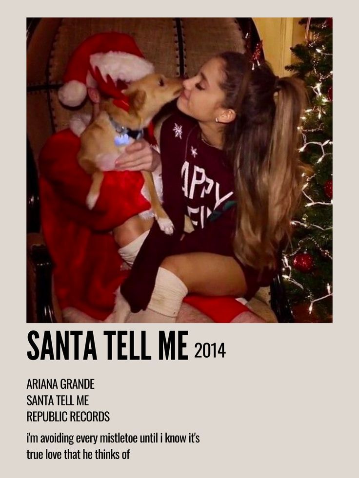 a woman kissing a small dog on top of a couch next to a christmas tree