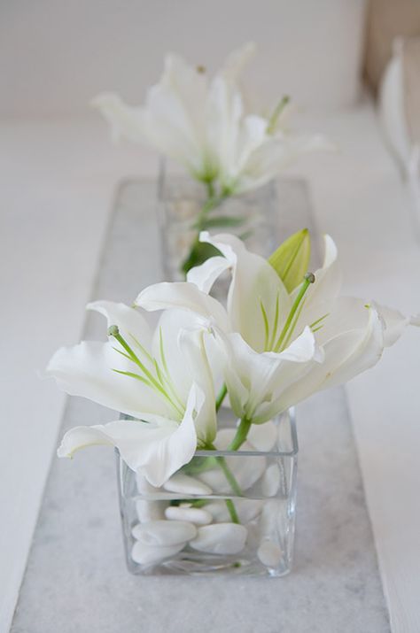 some white flowers are in a glass vase