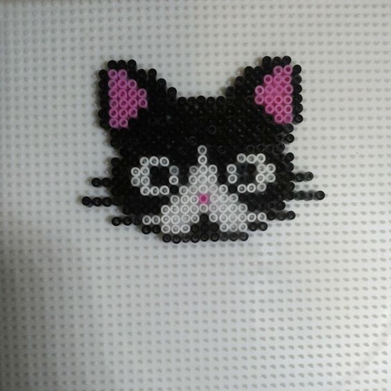 a black and white cat with pink ears on it's head is made out of legos