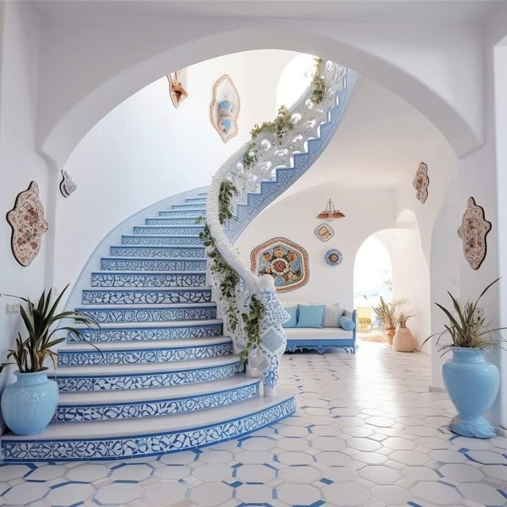 a blue and white staircase leading up to a living room with potted plants on either side