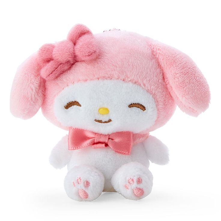 a small stuffed animal with a pink bow on its head and ears, sitting in front of a white background