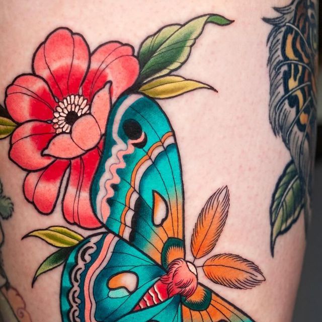 a close up of a butterfly with flowers on it's back leg tattoo design