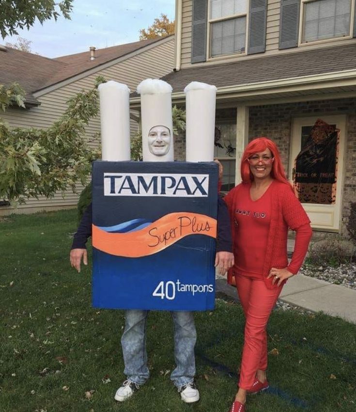 two people are standing in front of a sign that says tampa and the man is wearing an orange wig