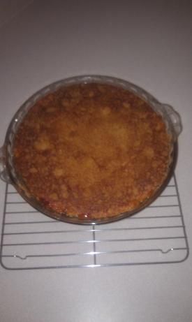 a baked pie sitting on top of a metal rack next to a white countertop