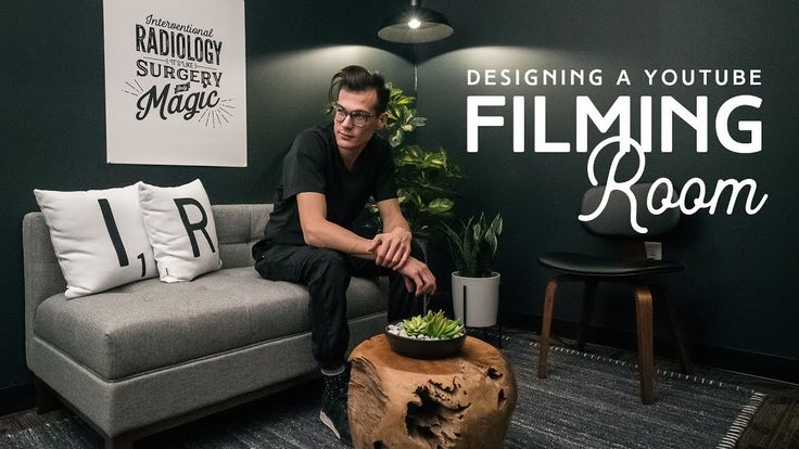 a man sitting on a couch in front of a green wall with the words designing a youtube