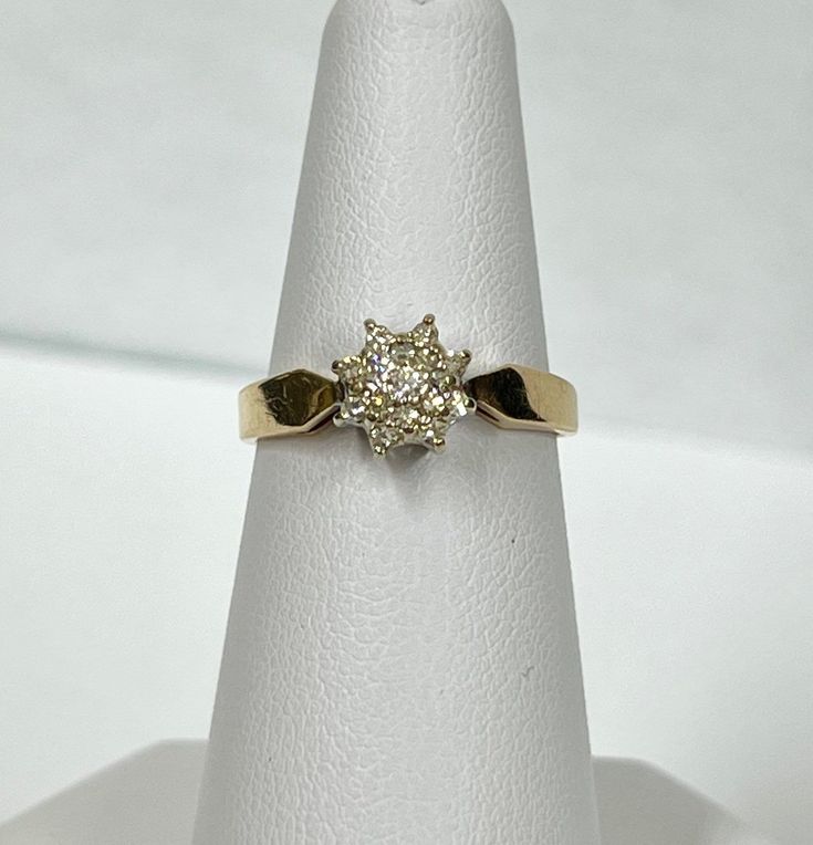 This ring is made with 14k gold, and has the 14k stamped inside the ring. Vintage with an unknown age, and is from an estate sale. It has one round brilliant cut diamond as the centre stone, and 16 single cut diamonds (all of them are natural diamonds) around the centre stone, all in white gold claw settings. Carat weight: 0.20 ct  Clarity: VS-SI Colour: G-H Cut: Good Item weight:  2.76 grams  Can be re-sized upon request, message our shop after purchase. This will delay the shipment date. The a 14k Gold Cluster Diamond Ring With Prong Setting, Yellow Gold Diamond Halo Ring Stamped 14k, Yellow Gold Halo Ring With Diamond, Stamped 14k, 14k Gold Diamond White Diamond Ring, White Diamond Ring In 14k Gold, Yellow Gold Diamond Ring With Brilliant Cut Cluster, 14k Stamped Diamond Halo Ring, 14k Diamond Rings For Anniversary, Yellow Gold Diamond Cluster Ring For Anniversary