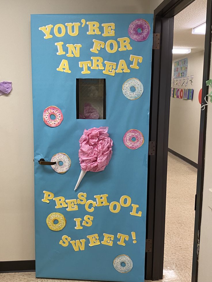 a door decorated with doughnuts and pink frosting for a school entrance decoration