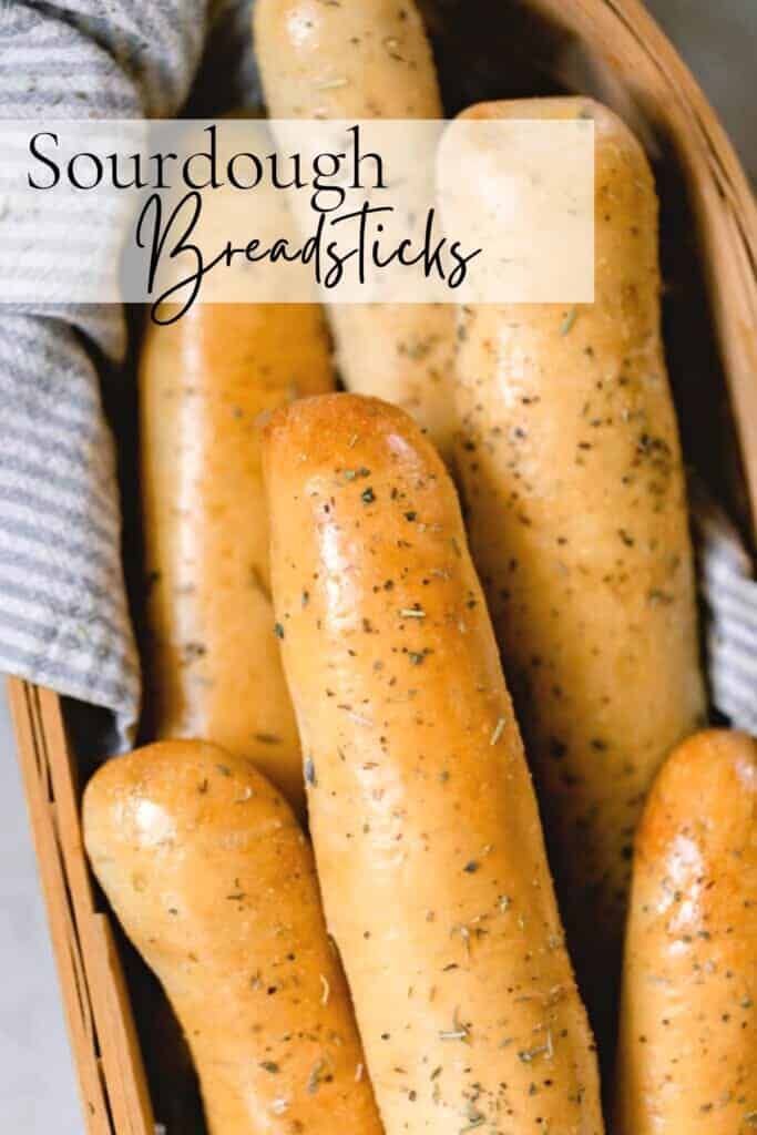 sausages in a basket with text overlay that reads sourdough breadsticks