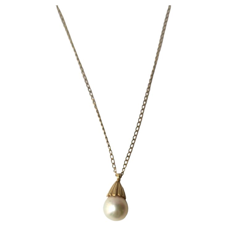 A very beautiful white cultured pearl on a 14-karat yellow gold necklace, circa mid-20th century. Pearl is very beautiful with a high luster. Pearl has a 14-karat yellow gold crown-like design at top attached to 14-karat yellow gold necklace. A beautiful piece to wear alone or stack with other necklaces (as demonstrated.) Very good condition as shown in images. No issues. Dimensions: pearl pendant is .50" long x .25" width. Necklace, from end to end, measures 19.25" long. For gold choker necklace shown, search 1stDibs ref. #: LU4068223052022 For Italian heart necklace search ref. #: LU4068222740332 Vintage Pendant Necklace, Pearl Necklace Vintage, Turquoise Pendant Necklace, Solitaire Pendant Necklace, Yellow Gold Necklace, Cultured Pearl Necklace, Coral And Gold, Gold Choker Necklace, White Gold Necklaces