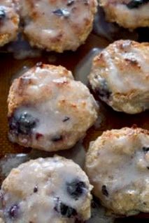 blueberry scones with icing on a baking sheet