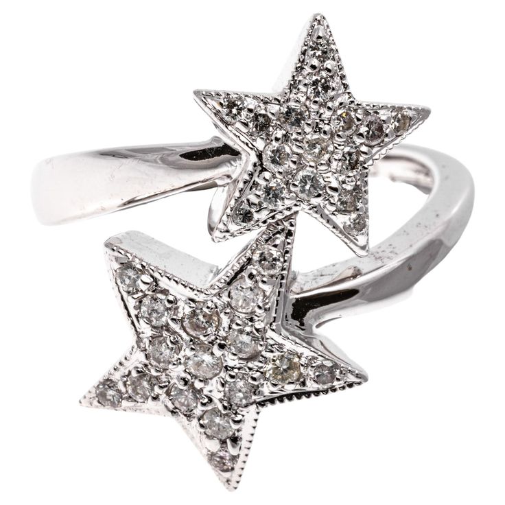 18k white gold ring. This playful ring is a bypass, crossover style, adorned with two complementary offset stars, decorated with round faceted diamonds, approximately 0.29 TCW, pave set and finished with a high polished shank. Marks: 750 Dimensions: 9/16" across the top x 3/4" wide Weight: 4.3 gross dwt Size: 6.5 Star Diamond Ring, Diamante Jewellery, Star Rings, Shiny Rings, Jewelry Design Inspiration, Contemporary Ring, Gold Cocktail, Wedding Rings Vintage, Star Ring